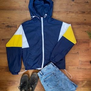 Garage zip up windbreaker with cinch-able bottom.